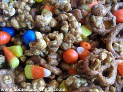 This Halloween caramel popcorn recipe is studded with the perfect amount of candy corn... get the recipe here!