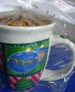 A coffee mug filled with rich and satisfying caramel latte popcorn and sealed in cellophane wrap, makes a cute homemade gift idea for co-workers, teachers and friends.