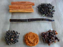 Wholes spices like cinnamon sticks, cloves, vanilla bean and peppercorns and Darjeeling black tea for chai tea mix