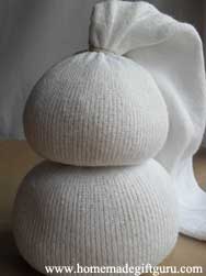 First make the body of your sock snowman. Rice makes a great filler but you can use dried beans if you prefer.