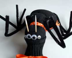 Paint two toothpicks white and allow them to dry. These will be the cute and SCARY teeth of your Halloween sock spider.